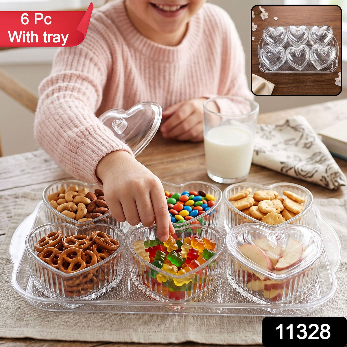 Six clear heart-shaped bowls with lids sit on a matching clear tray, filled with different colorful snacks on a wooden table.