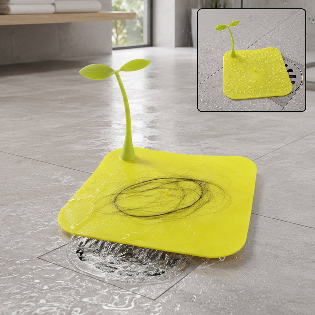 A bright yellow square silicone drain cover with a green sprout-like handle, collecting hair on a wet floor