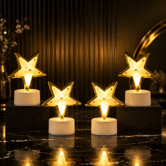Four glowing star-shaped LED lights arranged on a dark marble surface with a blurred background.