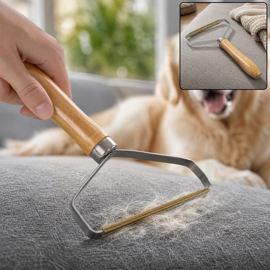 A hand uses a lint remover with a wooden handle and metal head to remove pet hair from a gray fabric surface, with a golden