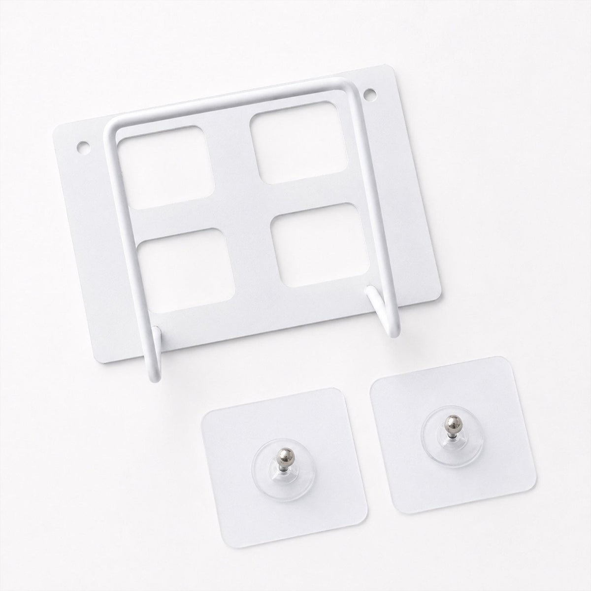 A white metal router mount with four square cutouts and two clear adhesive hooks on a white background.