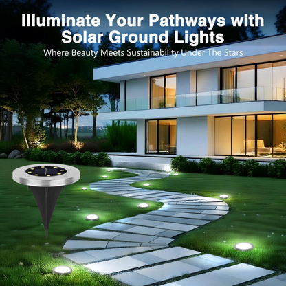 A single silver solar ground light is shown next to a winding stone path lit by several other ground lights in a garden at