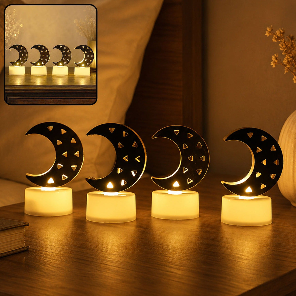Four crescent moon LED tea lights with warm yellow glow on a wooden nightstand with a bed in the background.