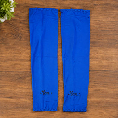 Two blue arm sleeves with the Ecoliz logo laid flat on a wooden surface next to a green plant.