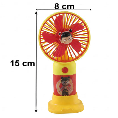 A red and yellow mini fan with a cartoon character face and stand, with dimensions of 15 cm and 8 cm.