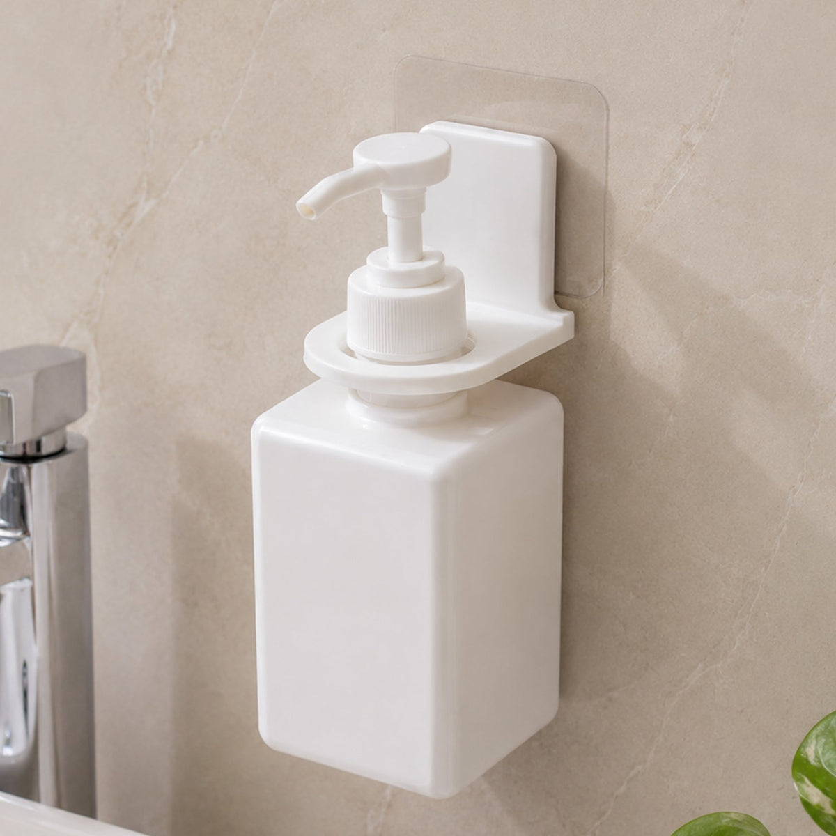Two white plastic bottle holders on a gray tiled wall, one holding a loofah and the other a white pump bottle.