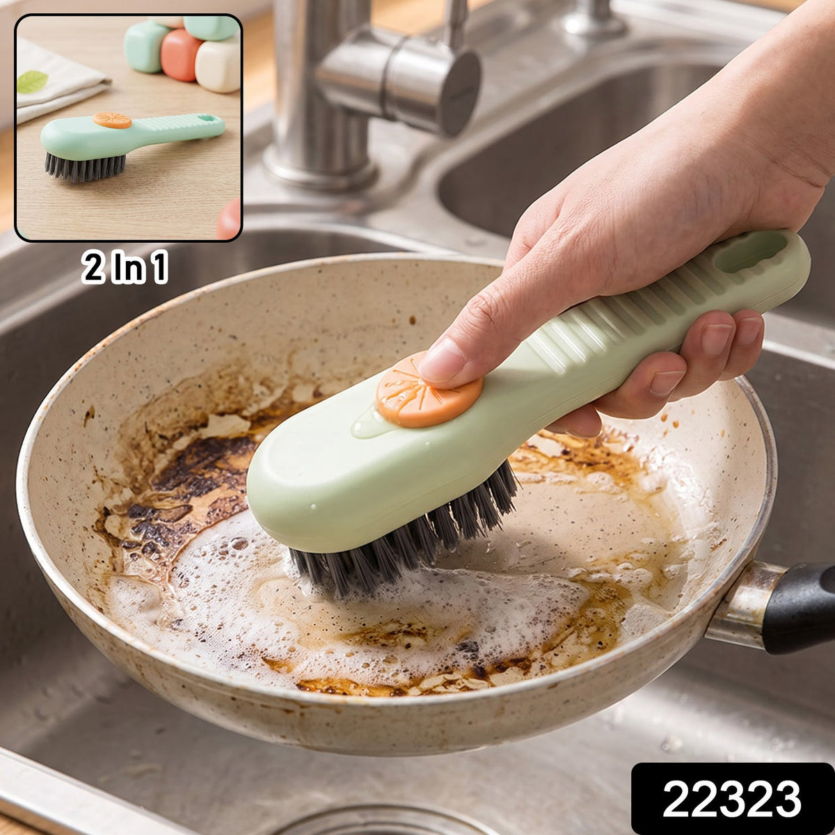A green and orange liquid-dispensing brush cleans a dirty frying pan in a stainless steel sink, with a small inset showing