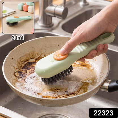 A green and orange liquid-dispensing brush cleans a dirty frying pan in a stainless steel sink, with a small inset showing