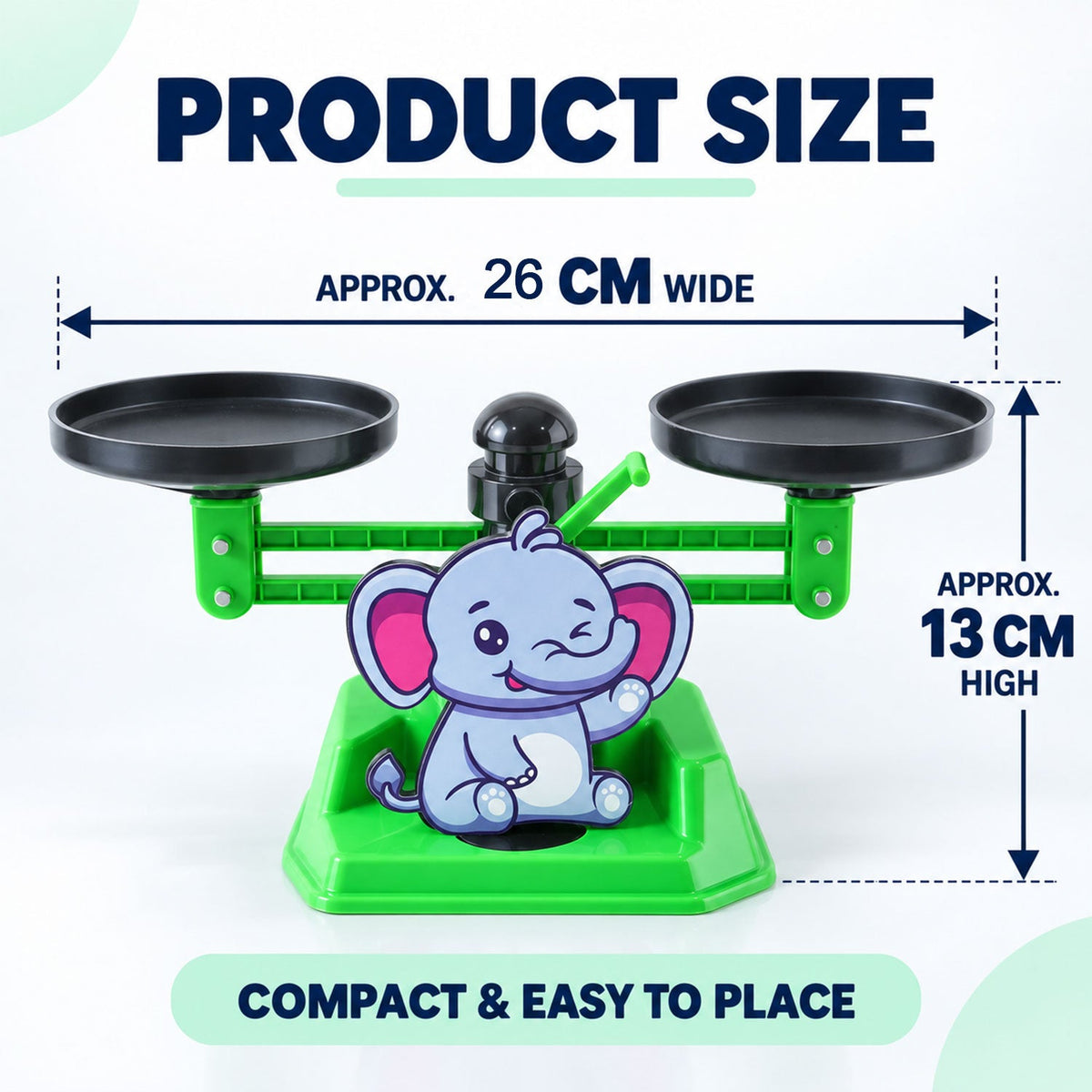 A green elephant math balance scale with black pans, showing approximate dimensions of 26 cm wide and 13 cm high.