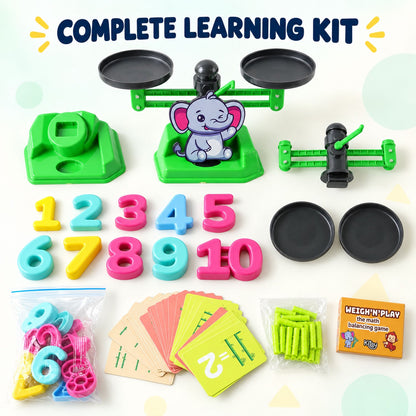 All components of the math balancing game laid out: a green scale, number pieces, rods, cards, and extra parts.
