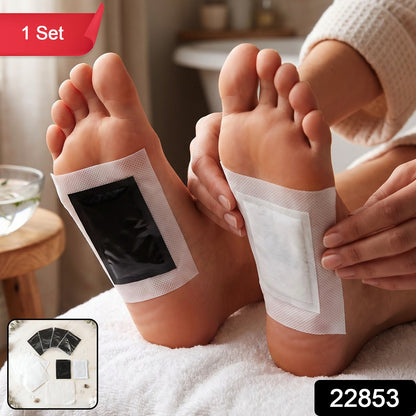 An overhead shot of various foot pad components, including black sachets and white adhesive sheets, on a marble surface.