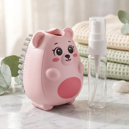 A pink bear-shaped cleaning brush with grey bristles sits next to a small clear spray bottle on a counter.