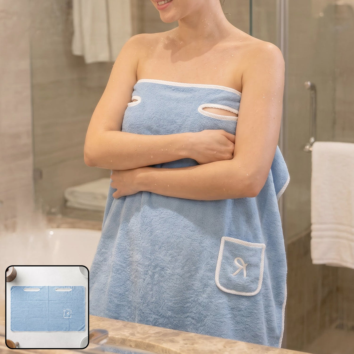 Woman wearing a light blue wearable bath towel with a white trim and a small pocket, standing in a bathroom.