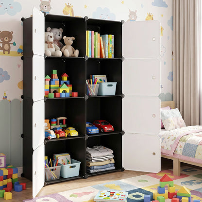 Black and white modular storage cabinet with open compartments filled with toys and books in a child's room.