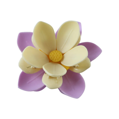 A fully assembled purple and yellow flower clip with a yellow center, viewed from above on a white background.
