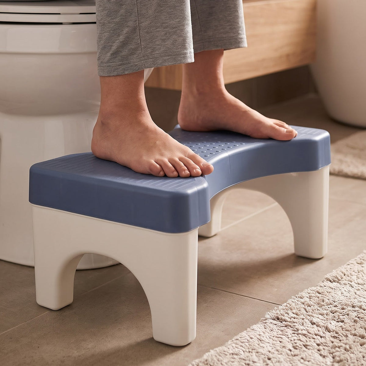 Stool tucked under the toilet when not in use