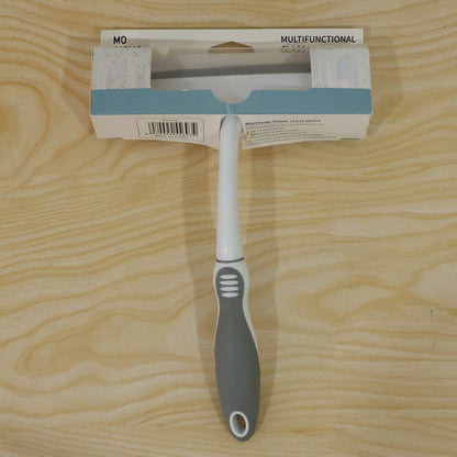A white and gray glass wiper in its packaging, displayed on a light wooden surface.