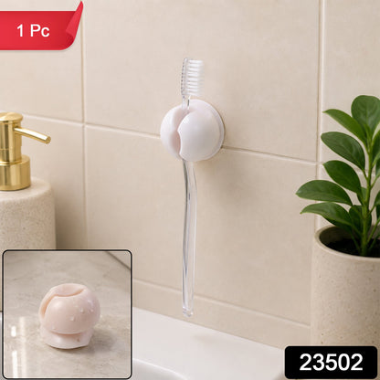 A white toothbrush holder clip on a tiled wall, holding a clear toothbrush above a sink, with a soap dispenser and – view 2