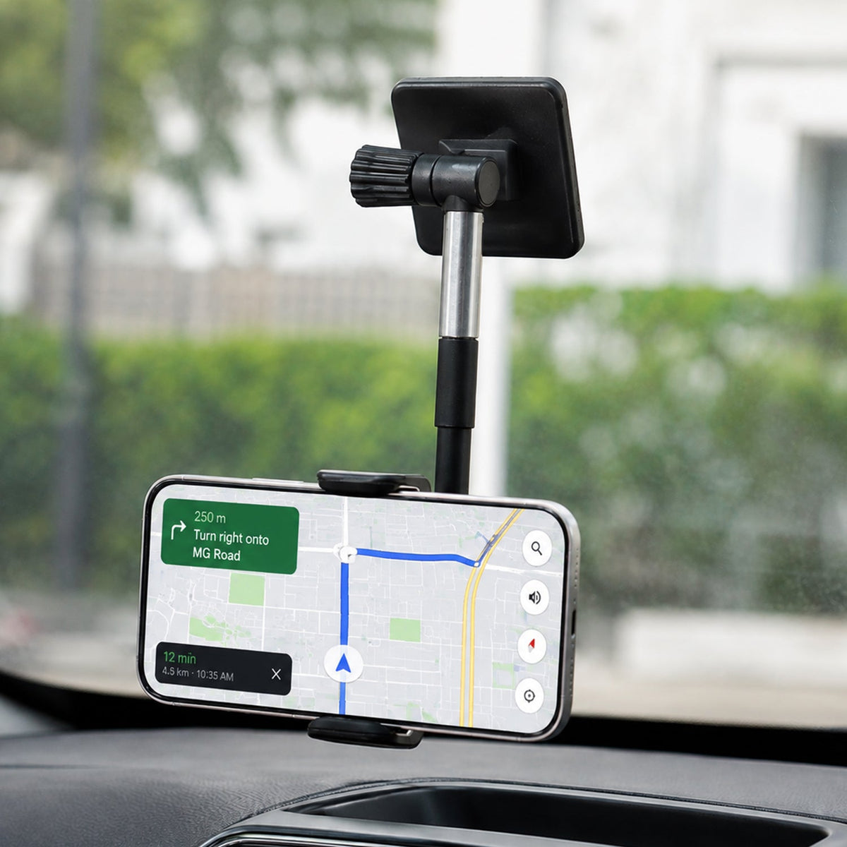 Black and silver car phone holder mounted on a dashboard, displaying a navigation map on a smartphone. – view 8
