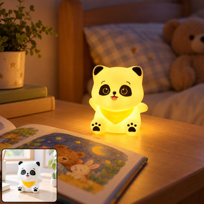 A glowing panda night light sits on a wooden bedside table next to an open storybook and a green plant.