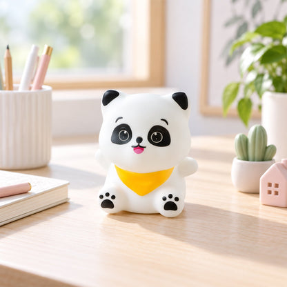 The panda night light sits unlit on a wooden desk with office supplies and small potted plants.