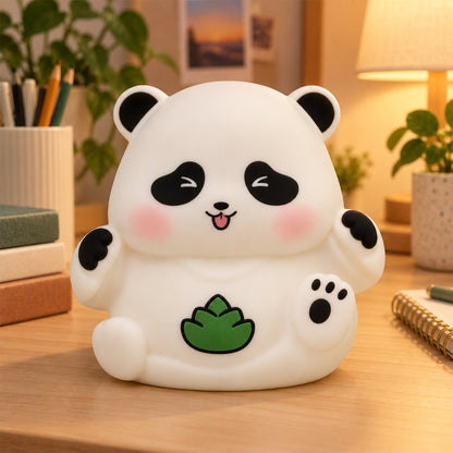 A white panda night light on a wooden desk, surrounded by books and a pen holder.