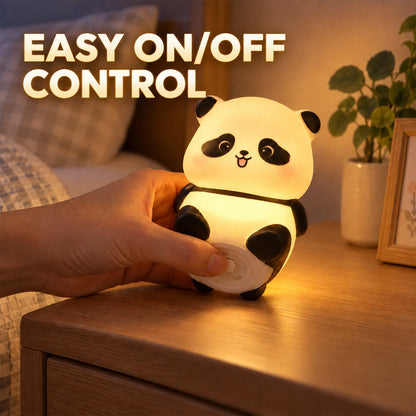 A hand presses the bottom of the glowing panda night light to demonstrate its easy on/off control.