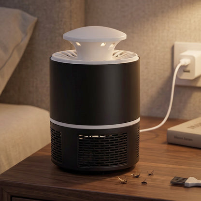 Black and white mosquito killer lamp on a bedside table with dead mosquitoes and a cleaning brush, with an inset image of