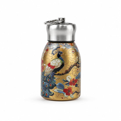 A golden stainless steel vacuum bottle with a vibrant peacock and floral print on a white background.