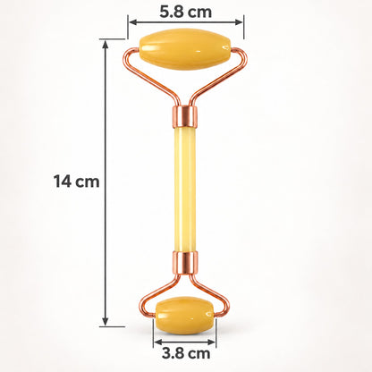 A yellow facial roller with rose gold accents is shown with its dimensions of 14 cm length and roller widths.