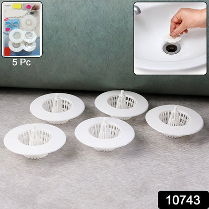 Five white plastic sink drain strainers are on a gray surface, with a product packaging inset and a sink use inset.