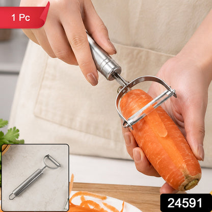 A person's hands using a silver stainless steel peeler to peel an orange carrot, with peeled shavings below, and a '1 Pc'
