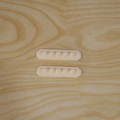 Pack of two self adhesive plastic wire cable organizer clips in their retail packaging.