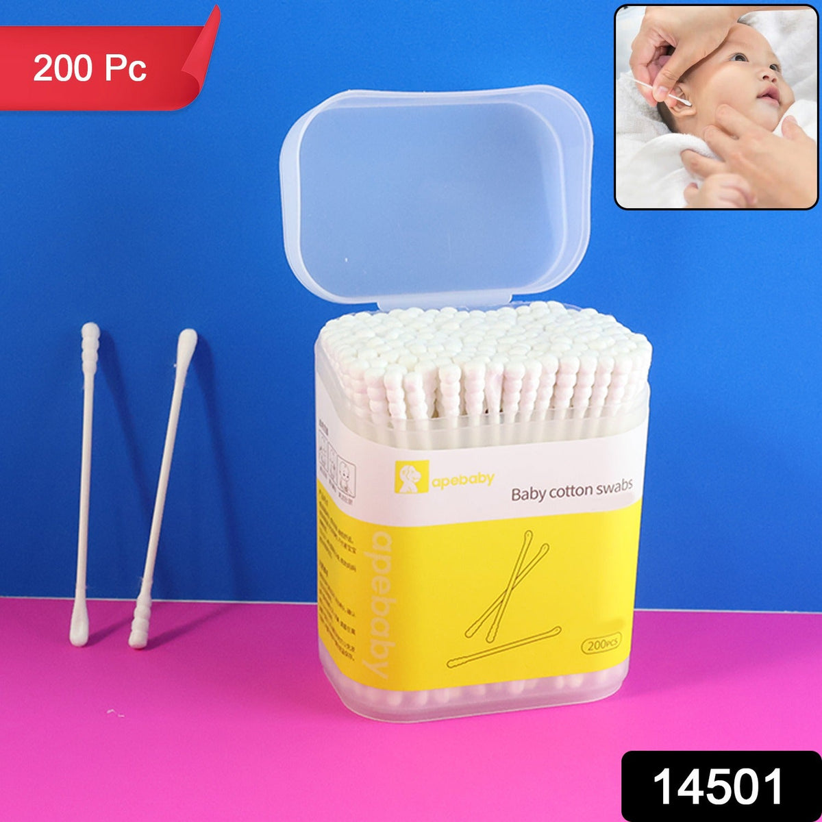 A clear plastic container of white baby cotton swabs with a yellow label, next to two loose swabs, with an inset of a hand.