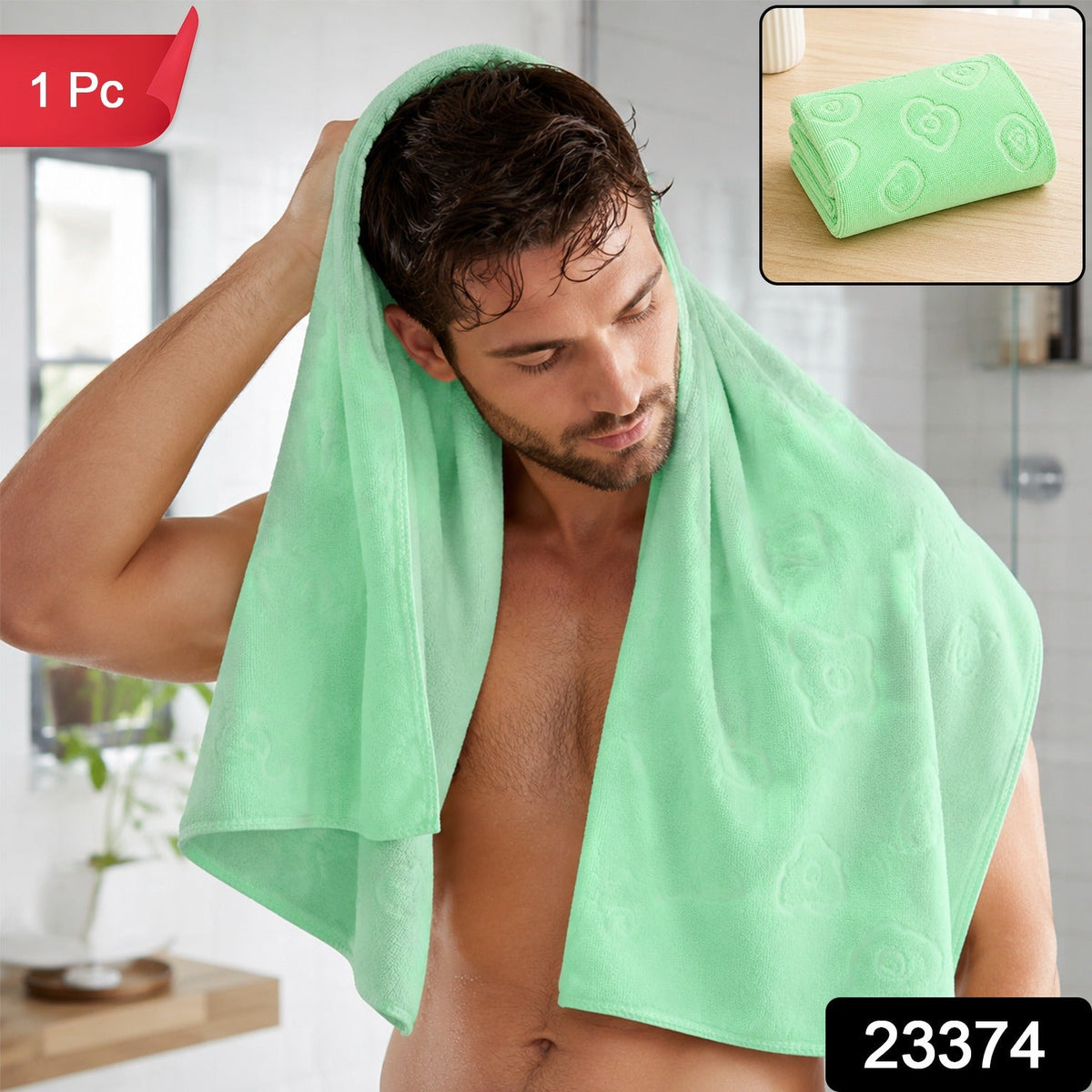 A man drying his hair with a light green microfiber towel in a bathroom, with a folded towel inset. – view 2