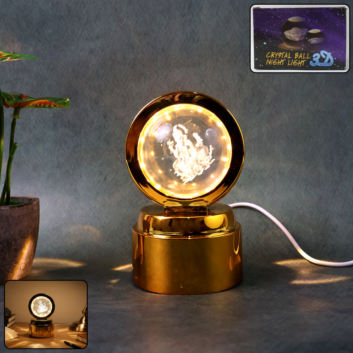 A golden-based LED night light with a clear crystal ball showing a 3D Ganpati figure, glowing warmly on a dark surface.