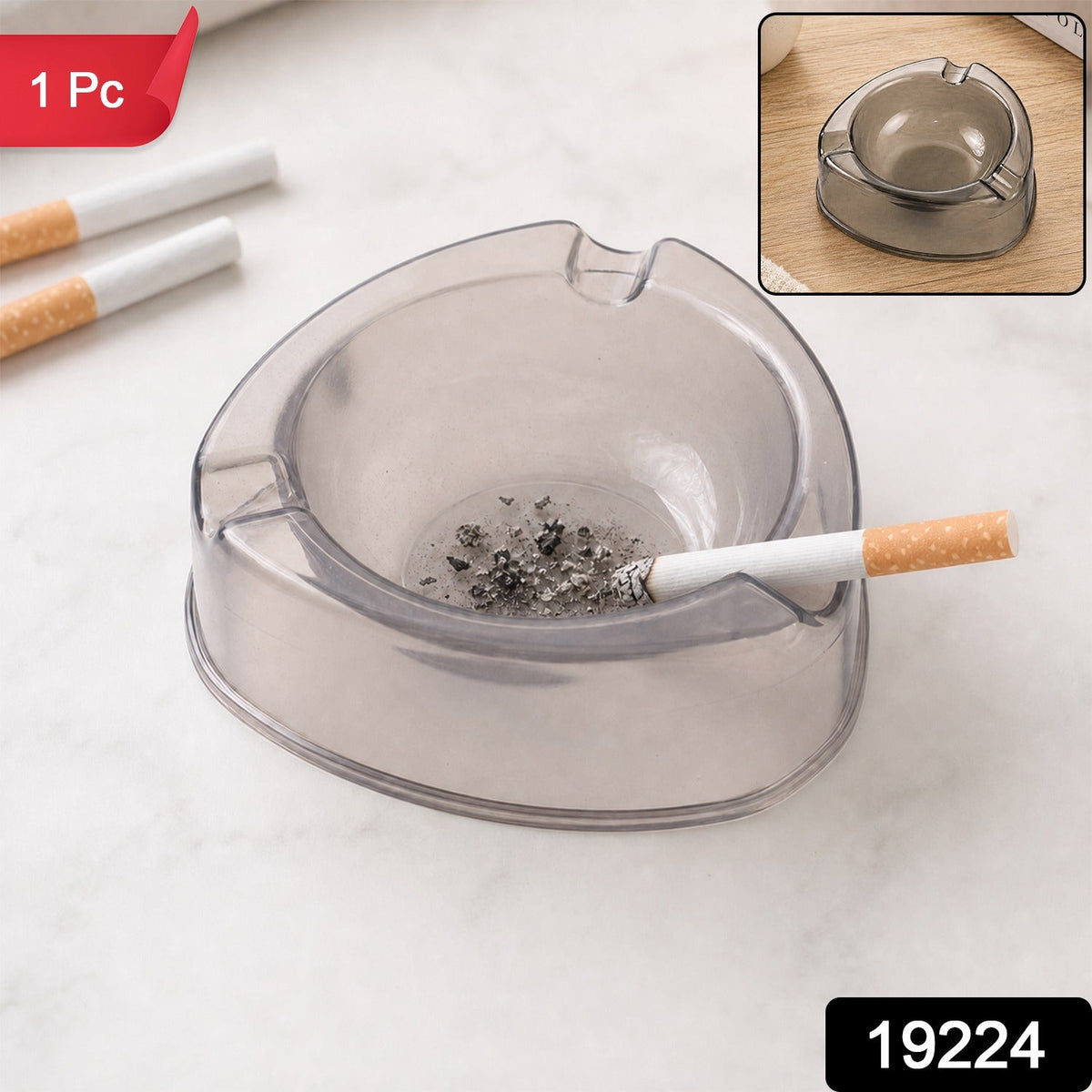 A sky blue transparent plastic ashtray is centered among cigarettes, coffee beans, sugar cubes, and a lighter.