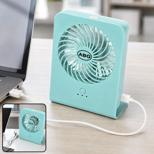 A mint green portable desk fan connected to a laptop via a white USB cable, with a close-up inset.