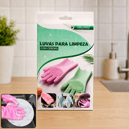 Product packaging for pink and green cleaning gloves with bristles, set on a kitchen counter.