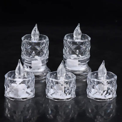 Five clear acrylic flameless LED tealight candles with clear plastic flames on a black reflective surface.