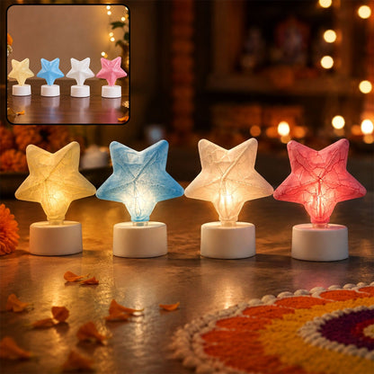 Four glowing star-shaped LED tealight candles in yellow, blue, white, and pink on a festive floor with petals.