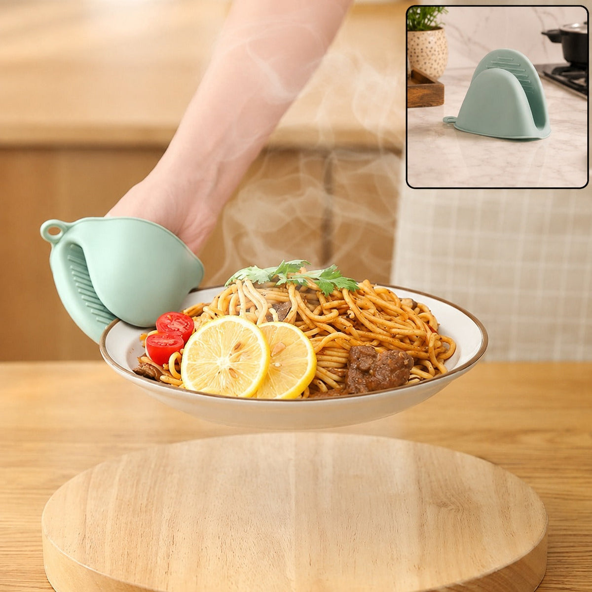 A hand wearing a green silicone mini oven mitt holds a steaming plate of spaghetti with lemon slices, with an inset of the