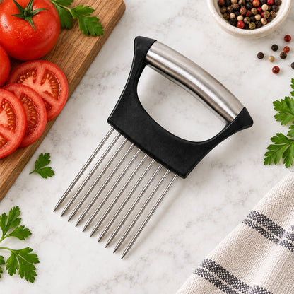 A black and silver onion holder with ten prongs sits on a white marble counter next to sliced red tomatoes.