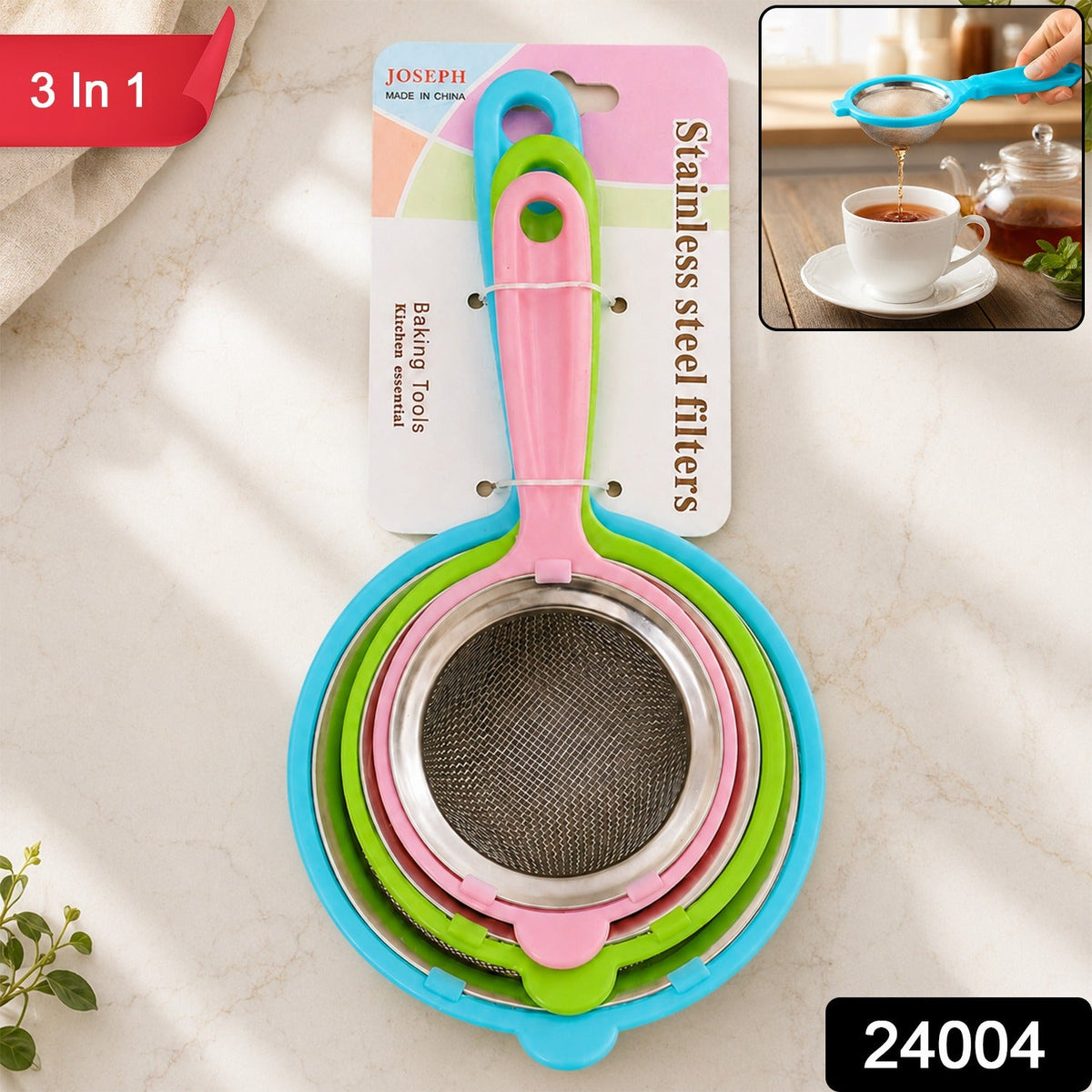 Three nested strainers with colorful plastic handles and stainless steel mesh, packaged together on a white countertop with