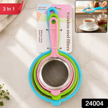 Three nested strainers with colorful plastic handles and stainless steel mesh, packaged together on a white countertop with