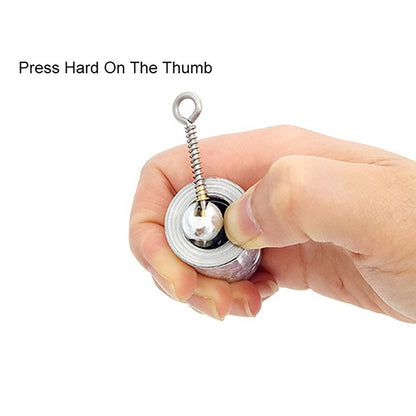 A hand presses a thumb on the release mechanism of the compact silver collapsible cane.