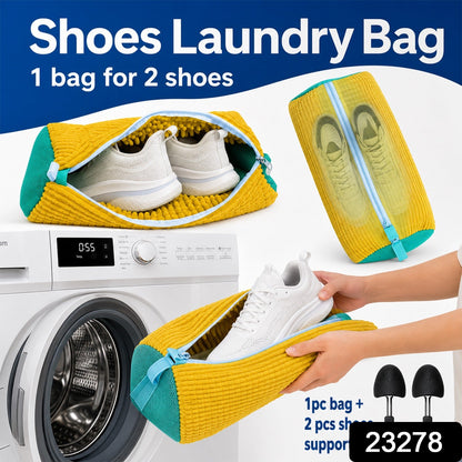 A yellow and blue shoe laundry bag with two white shoes inside, next to a washing machine and two black shoe supports, with