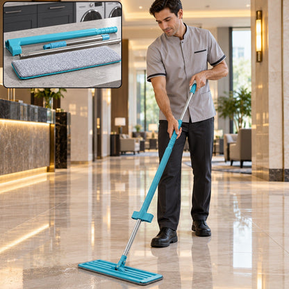 A man in a grey uniform mops a shiny tiled floor in a hotel lobby with a blue and silver mop.