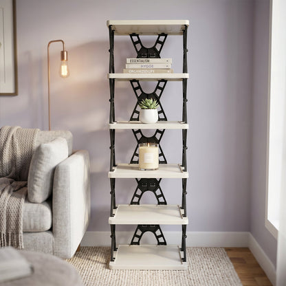 A light grey and black foldable shoe rack in a living room, holding books, a small plant, and a candle.