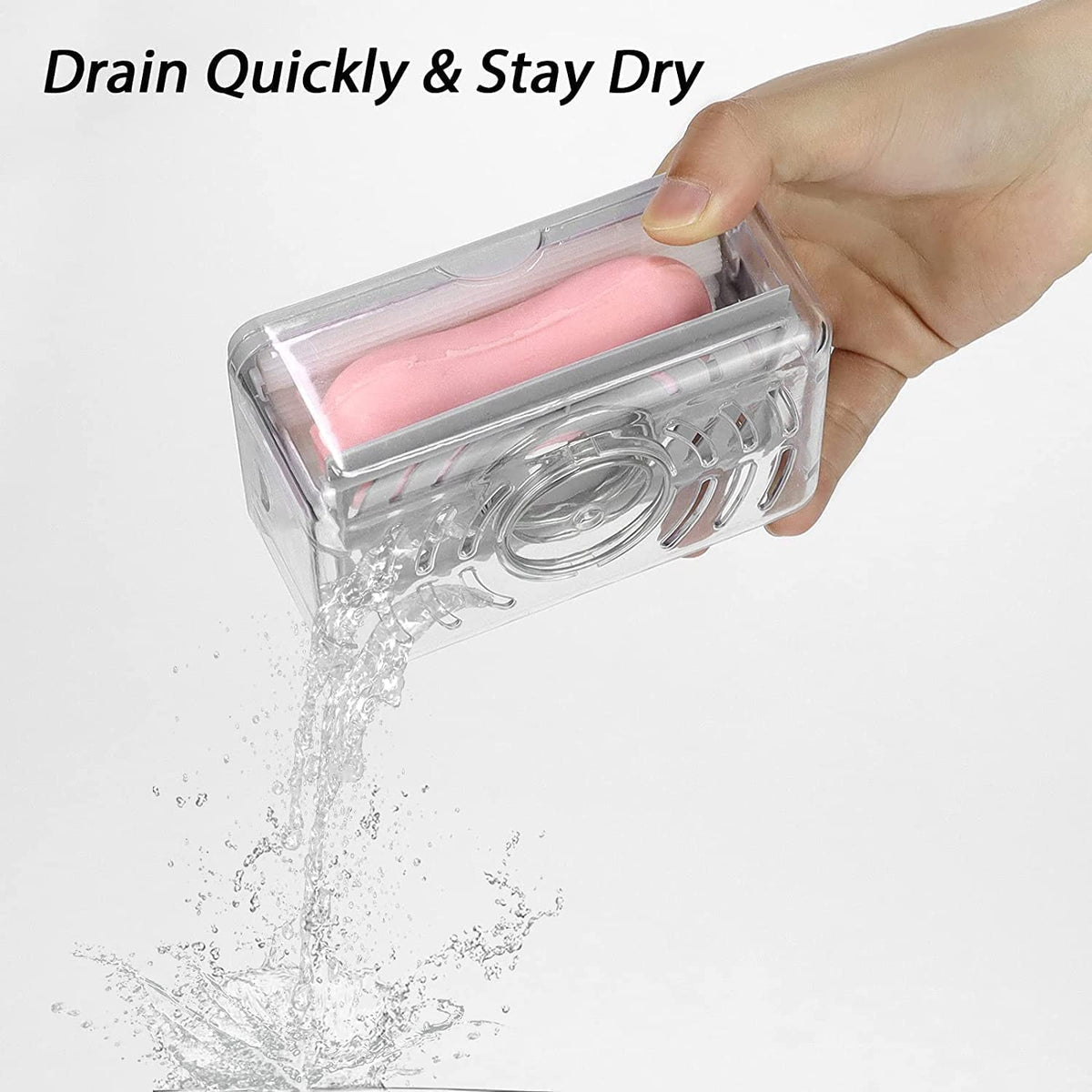 A hand holds the clear soap dispenser, draining water from a pink soap bar inside.